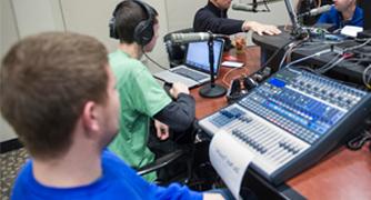 Image of student recording a podcast